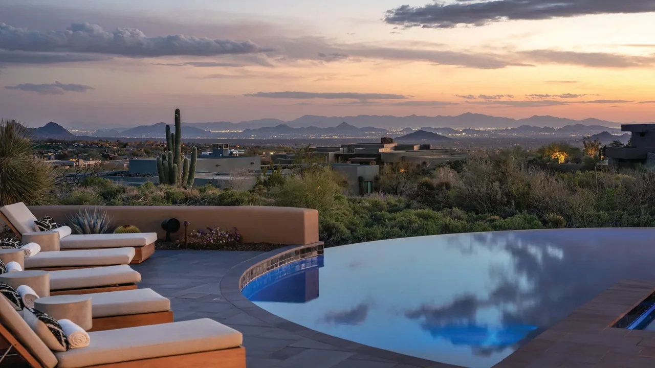 Luxury infinity edge pool overlooking Arizona desert landscape at sunset